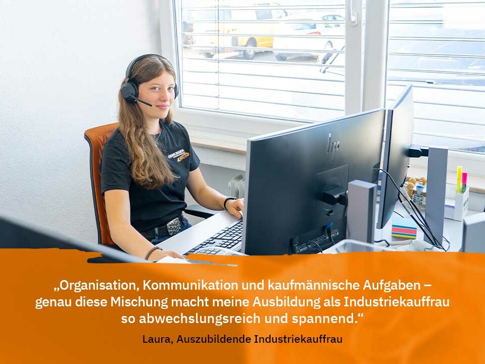 Die Auszubildende Laura von Genkinger arbeitet an ihrem PC und beschreibt ihre Ausbildung als Industriekauffrau mit Fokus auf Organisation, Kommunikation und kaufmännische Aufgaben.